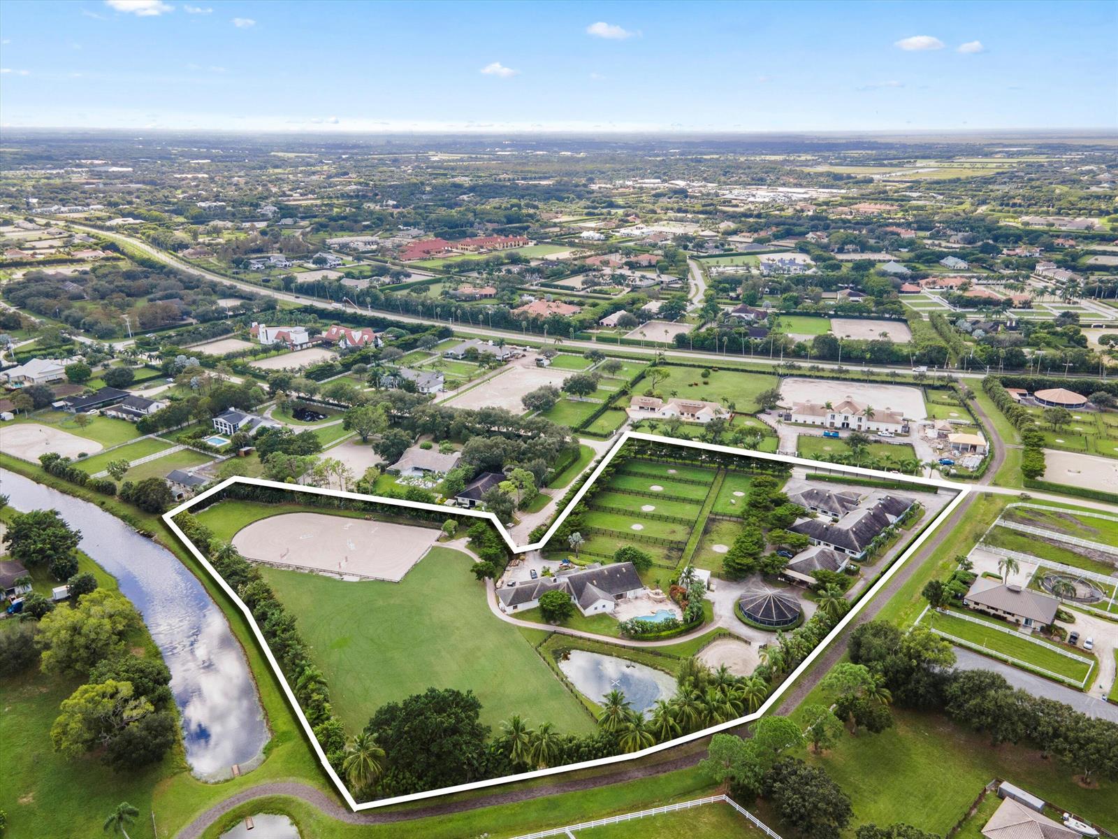 An aerial view shows a large equestrian estate with a house, stables, and riding arena — 2388 King Terrace, Wellington FL 33414, WELLINGTON, FL
