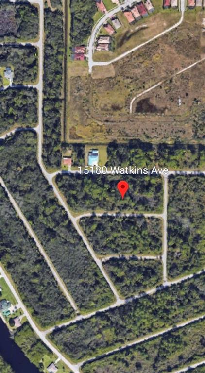 This is an aerial map view of a residential neighborhood with streets and canals — 15180 WATKINS AVENUE, PORT CHARLOTTE, FL