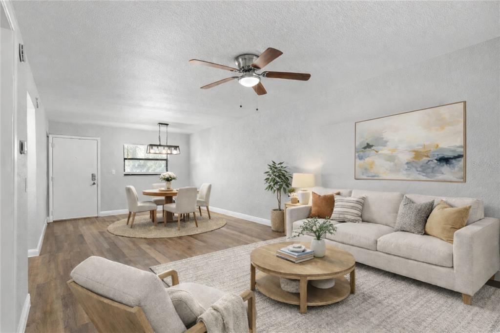 A kitchen with white cabinets, stainless steel appliances, a light countertop, and a tiled backsplash — 3034 EASTLAND BOULEVARD UNIT D104, CLEARWATER, FL