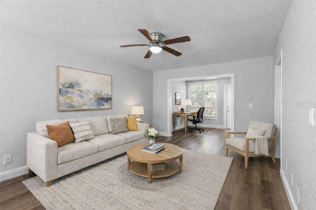 A dining room with a round wooden table, four chairs, and a hanging light fixture — 3034 EASTLAND BOULEVARD UNIT D104, CLEARWATER, FL