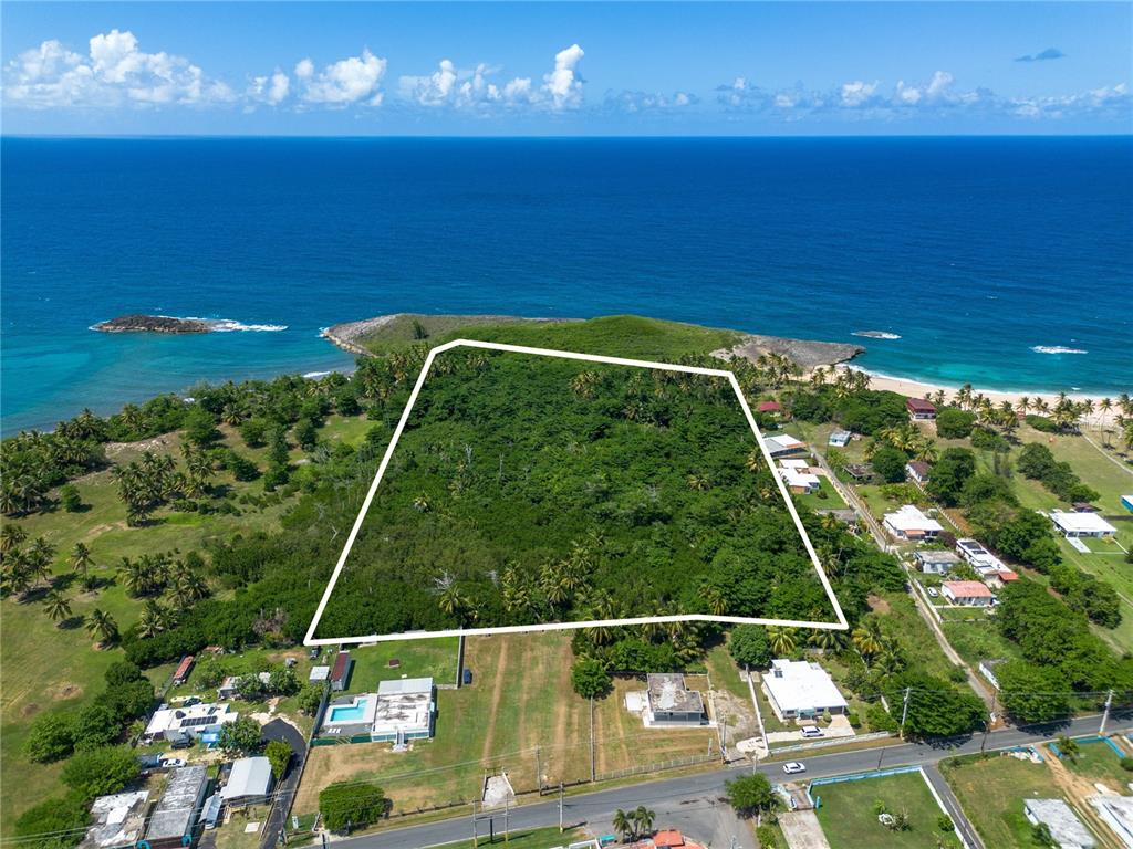An aerial view shows a large, undeveloped plot of land outlined in white near the ocean — Carr 681 Km 4.5 BO.ISLOTE, ARECIBO, PR