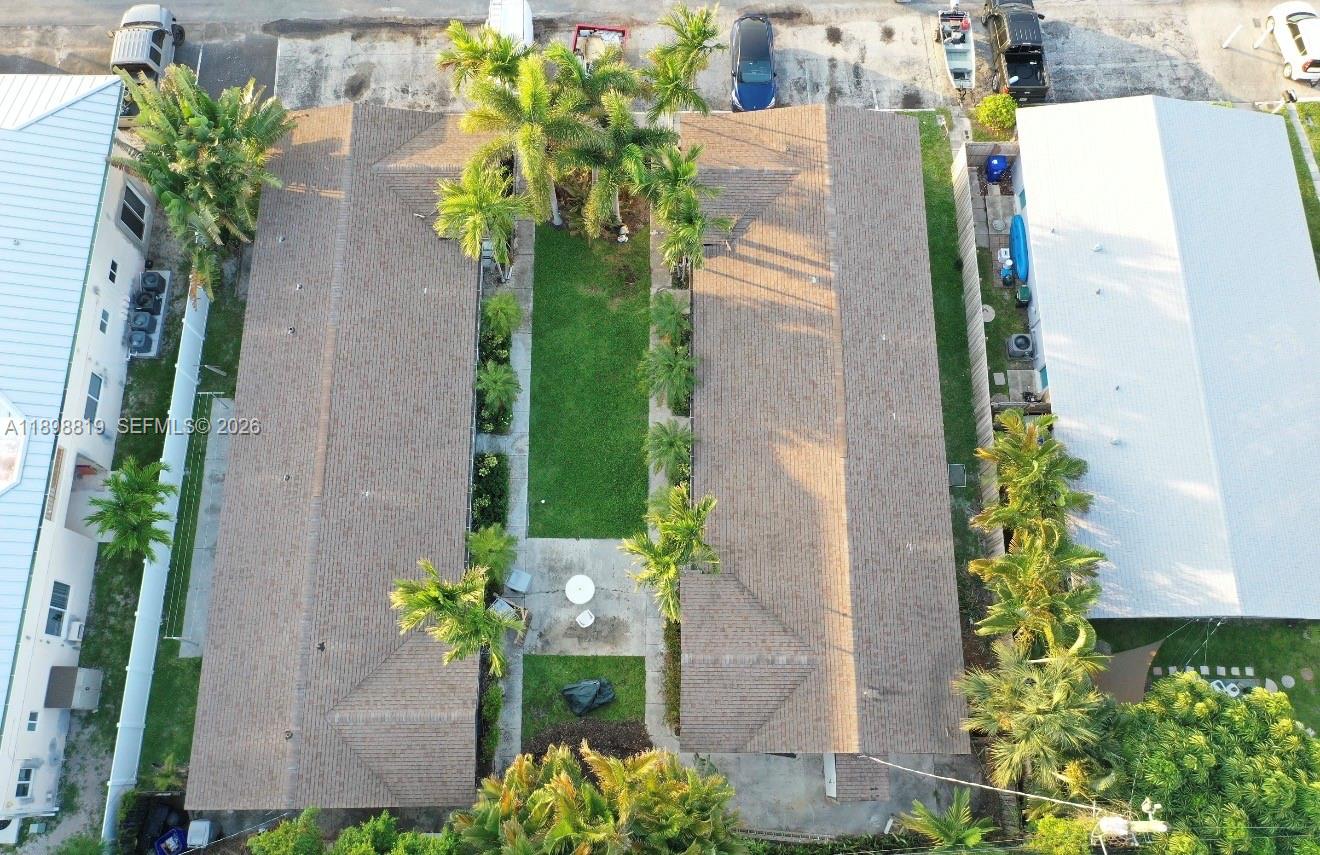 An aerial view shows two parallel buildings with a central courtyard and palm trees — 3208 Canal Dr # 4, Pompano Beach FL 33062, POMPANO BEACH, FL