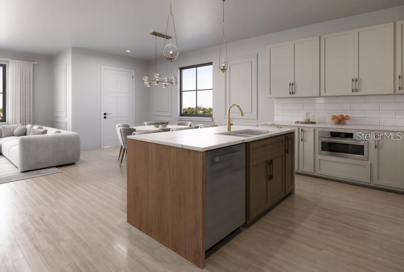 This is a rendering of a modern kitchen with a wood-toned island and light-colored cabinetry — 636 SIGLER DRIVE, WINTER GARDEN, FL