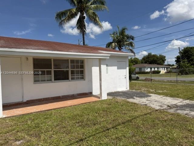 A single-story house with a white exterior, a brown roof, and a palm tree nearby — 2115 SW 50th Ave, West Park FL 33023, WEST PARK, FL