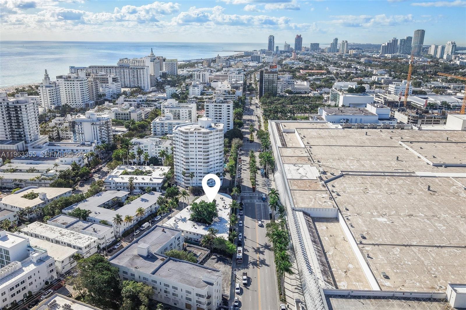 An aerial view shows a low-rise building marked by a pin in a dense city — 1925 Washington Ave # 21, Miami Beach FL 33139, MIAMI BEACH, FL