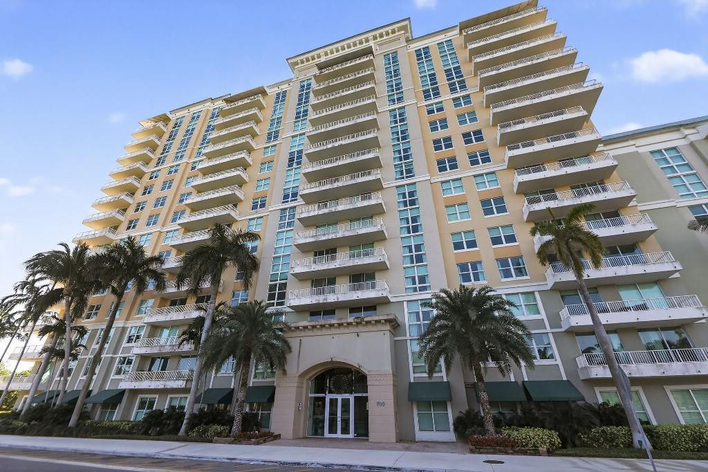 A low-angle exterior view of a multi-story residential building with balconies and palm trees — 700 E Boynton Beach Boulevard # 1006, Boynton Beach FL 33435, BOYNTON BEACH, FL
