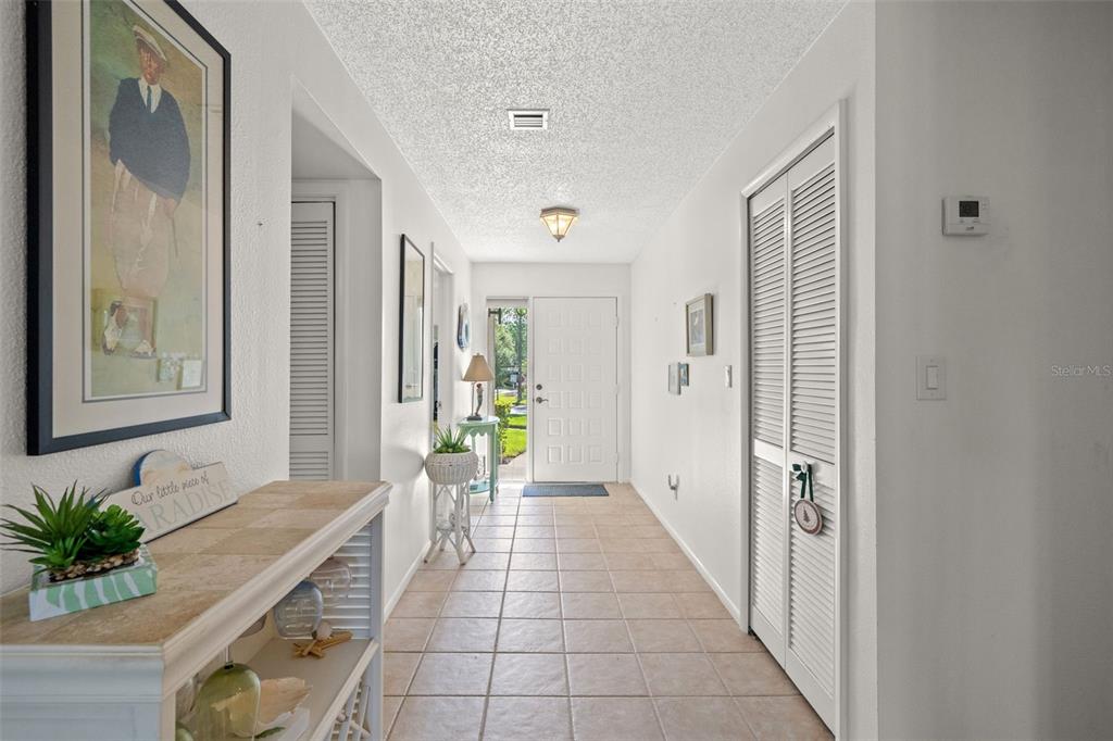 A bright entryway features a tiled floor, white walls, and a white front door — 140 ASHLEY LANE, OLDSMAR, FL