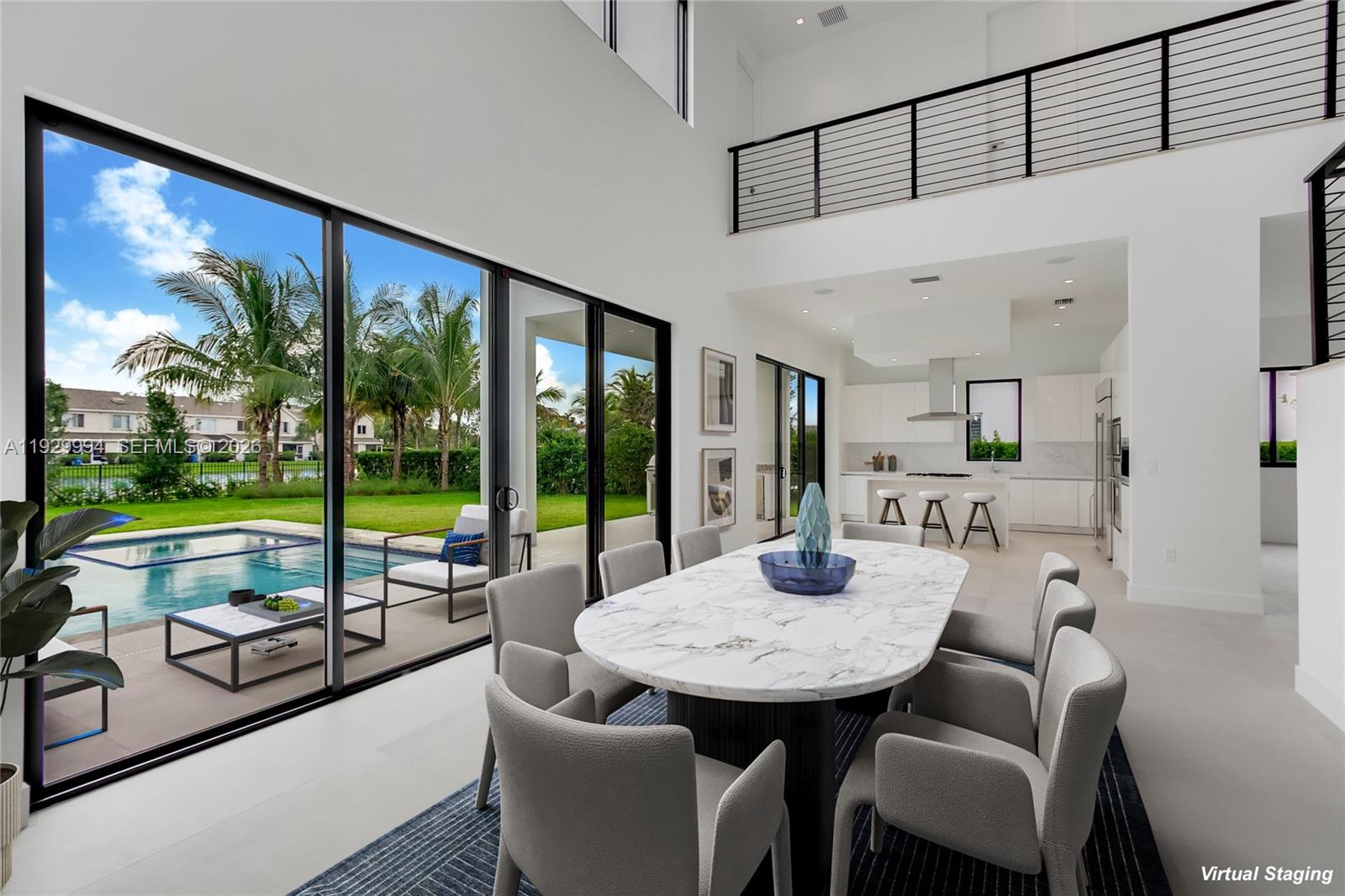 A dining area with a marble table overlooks a swimming pool through large sliding glass doors — 16492 S Botaniko Dr S, Weston FL 33326, WESTON, FL