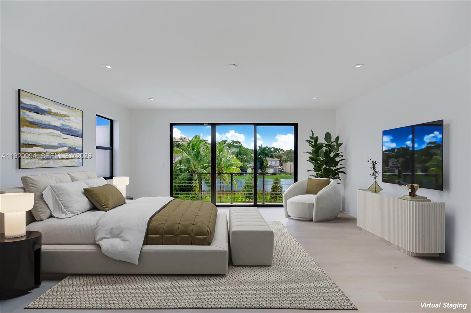 This bedroom features a bed, a sitting area, and large sliding doors overlooking a lake — 16492 S Botaniko Dr S, Weston FL 33326, WESTON, FL