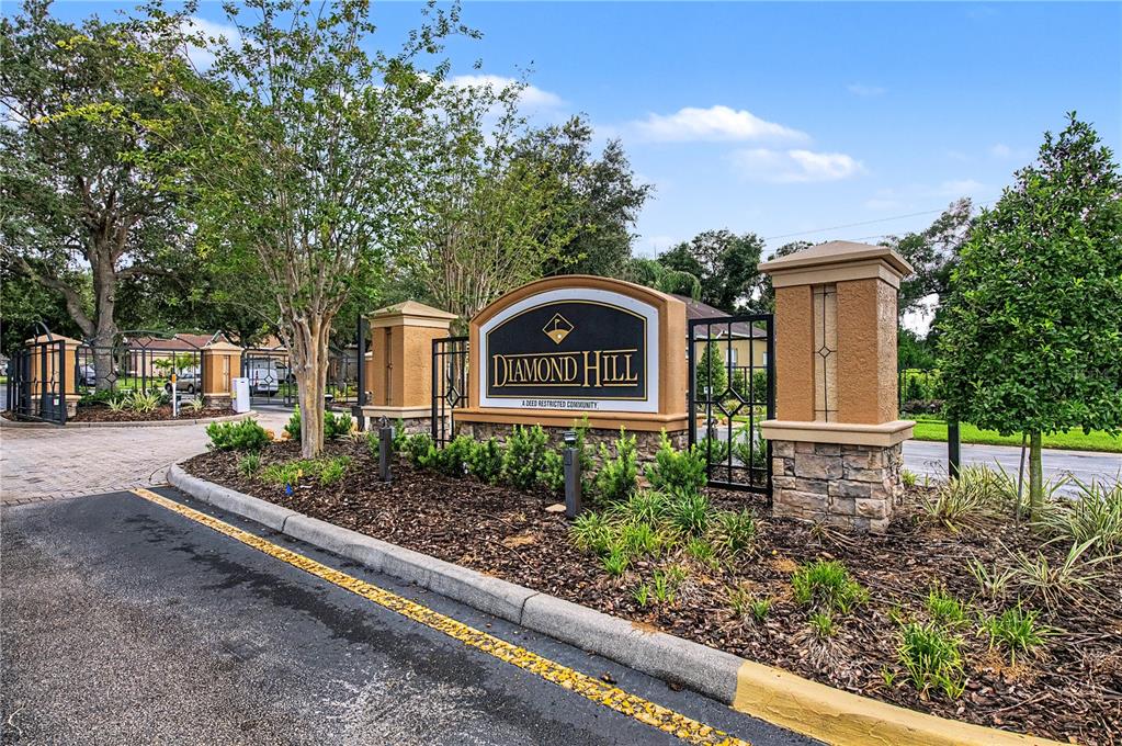 The entrance sign for Diamond Hill community features stone pillars and a gated driveway — 2418 BLUE STONE COURT, VALRICO, FL