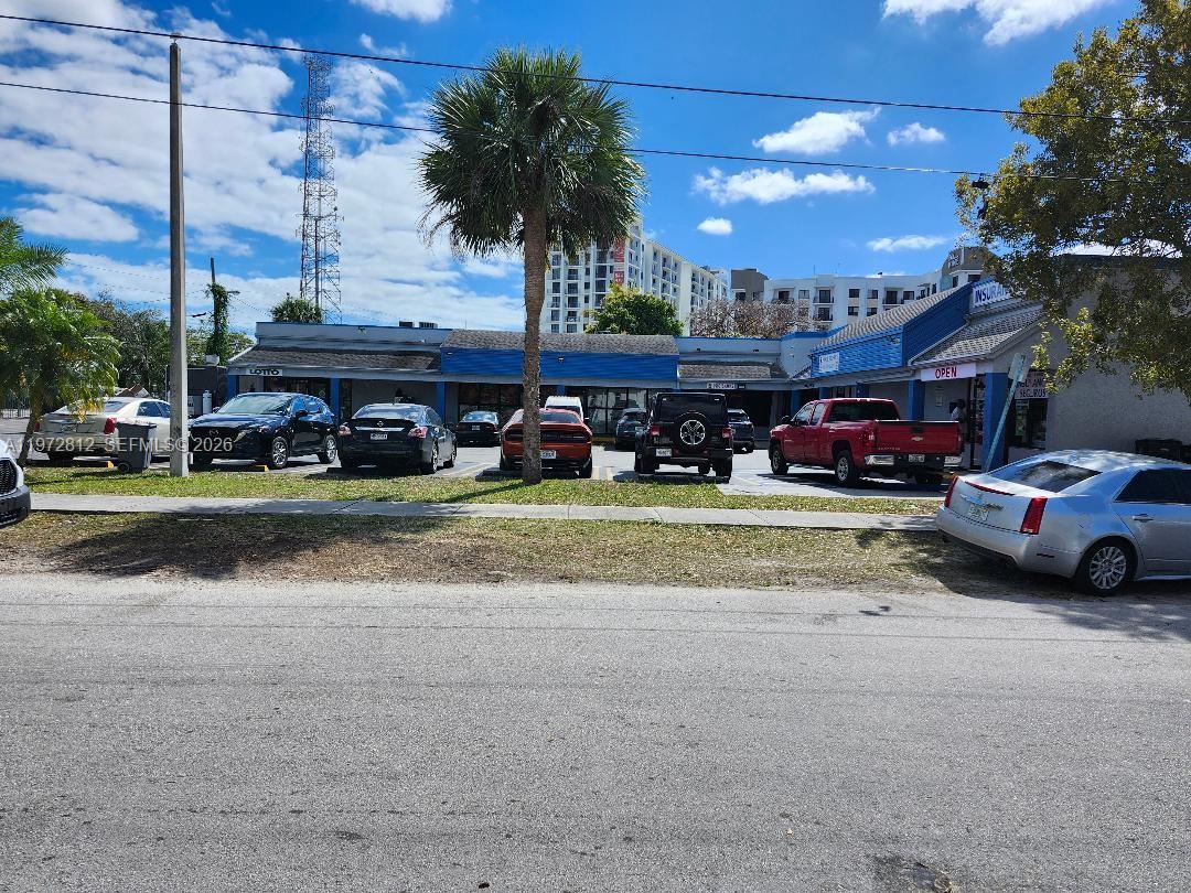 A single-story commercial strip mall with a parking lot and a palm tree in front — 10200 SW 183rd St, Miami FL 33157, MIAMI, FL