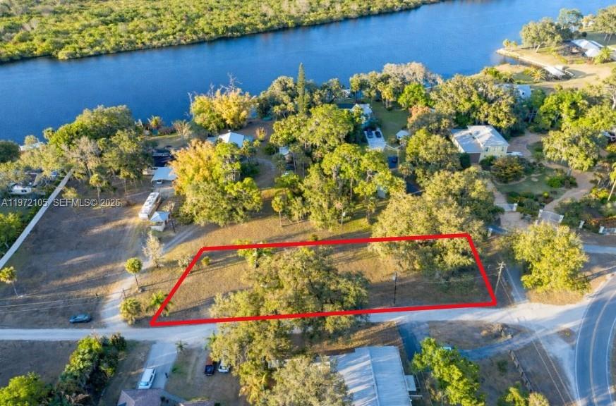 An aerial view shows a rectangular vacant lot outlined in red near a river — 2014 Ft Denaud Rd, La Belle FL 33935, LA BELLE, FL