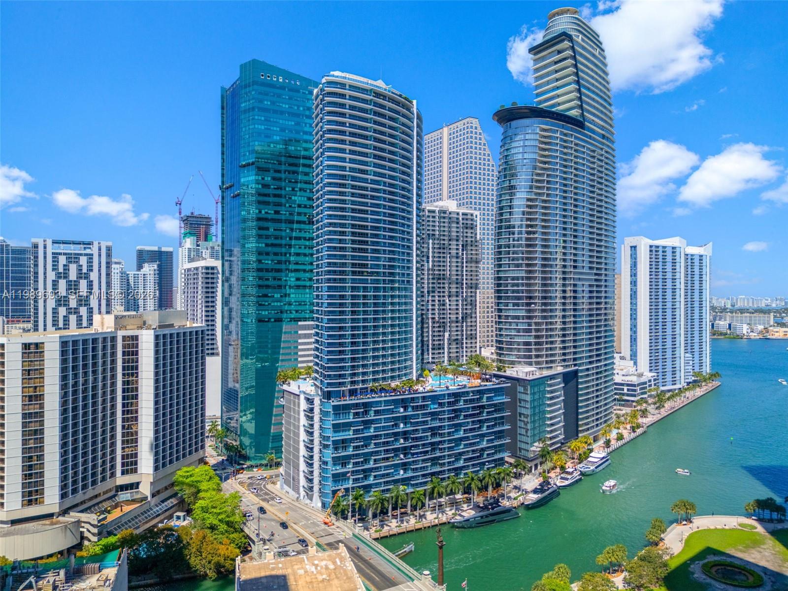 An aerial view of modern high-rise buildings along a canal in a coastal city — 200 Biscayne Boulevard Way # 3707, Miami FL 33131, MIAMI, FL