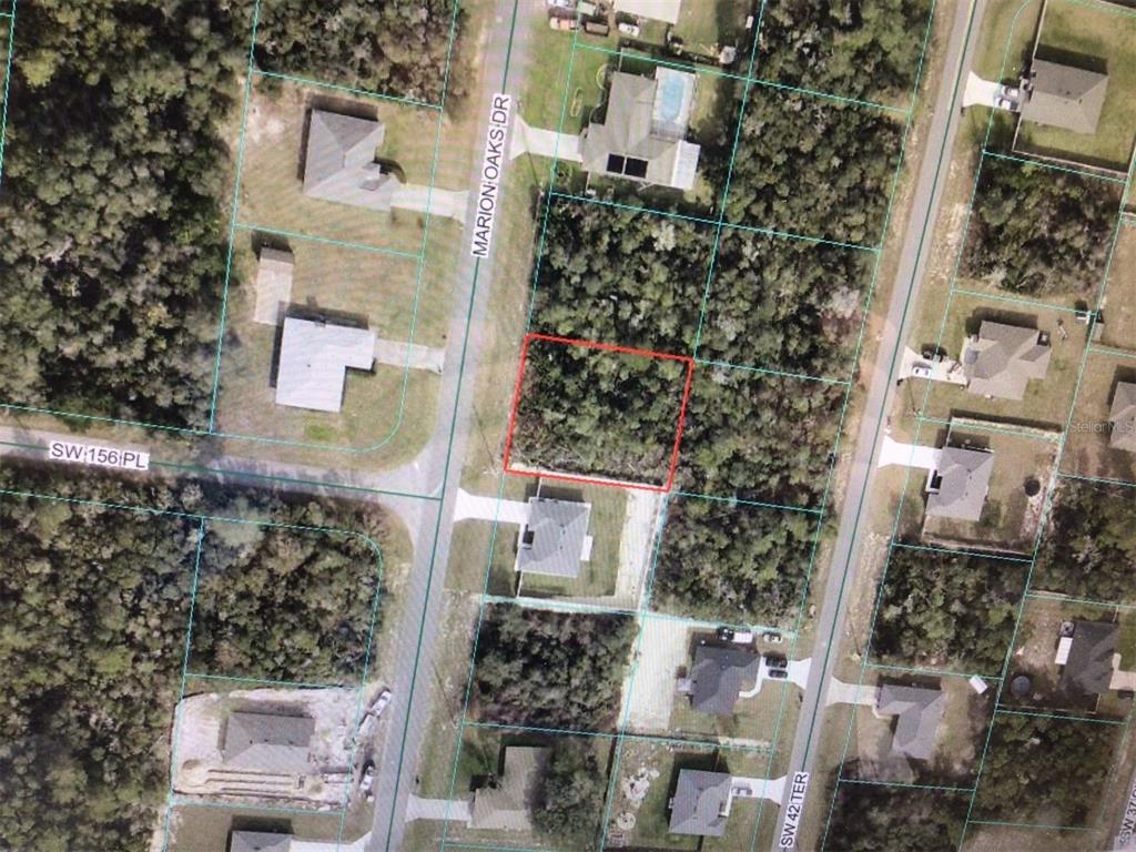 An aerial view shows a vacant, wooded residential lot outlined in red — MARION OAKS DRIVE, OCALA, FL