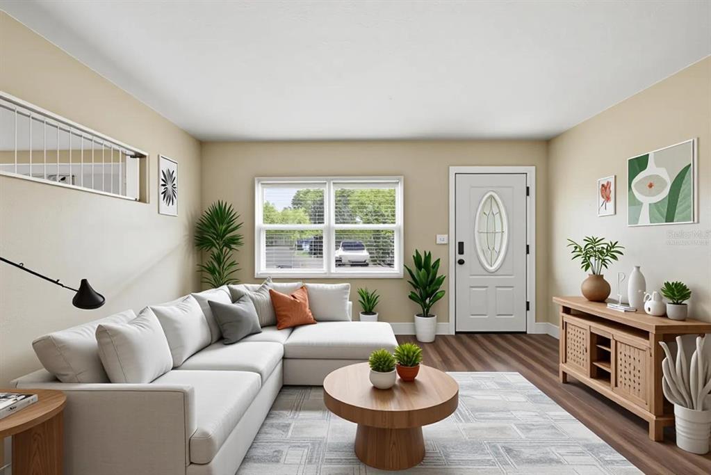 This living room features a sectional sofa, a round coffee table, and a wood media console — 5714 LEJEUNE DRIVE, ORLANDO, FL
