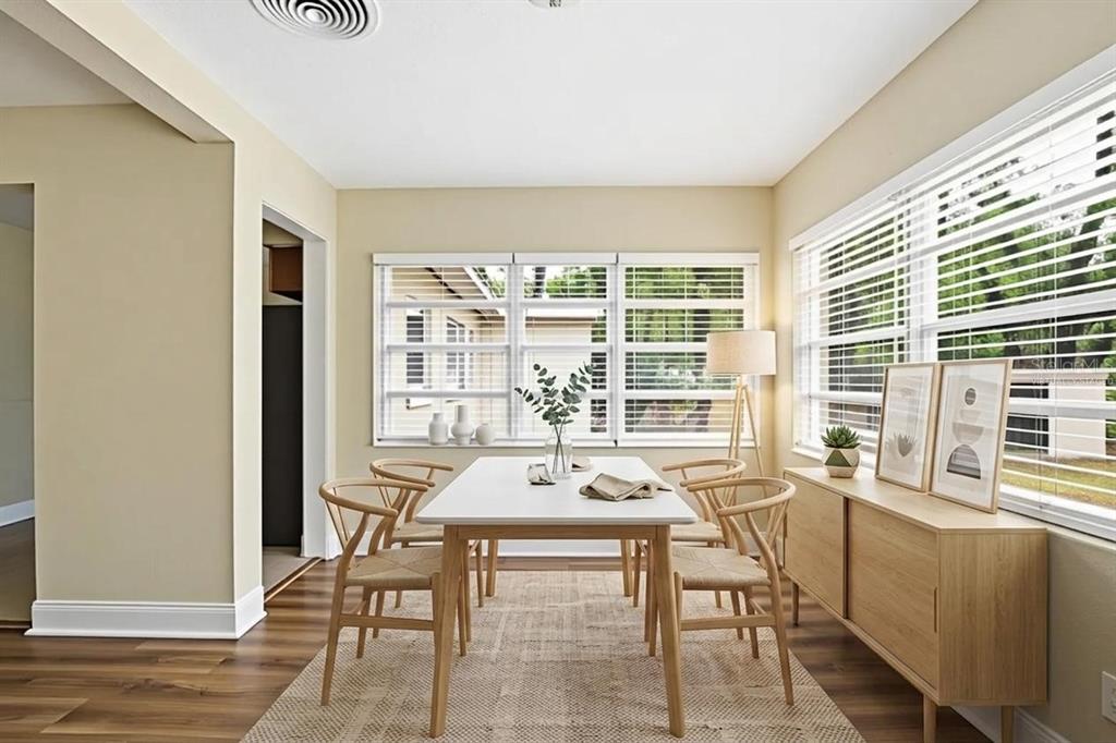 A dining room features a white table, four wooden chairs, and a light wood sideboard — 5714 LEJEUNE DRIVE, ORLANDO, FL