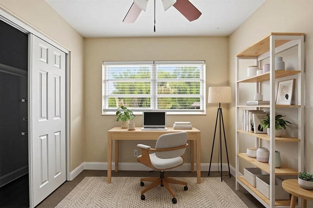A home office featuring a desk, chair, bookshelf, and a window with a view — 5714 LEJEUNE DRIVE, ORLANDO, FL