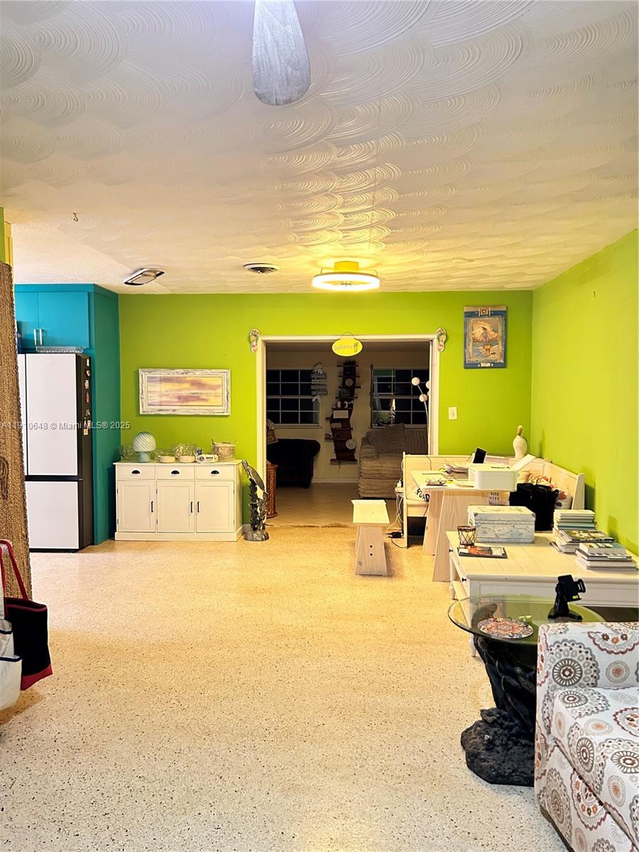 A lime green living area features a white sideboard, a dining nook, and terrazzo flooring — 118 Bougainvillea Dr, Rockledge FL 32955, ROCKLEDGE, FL