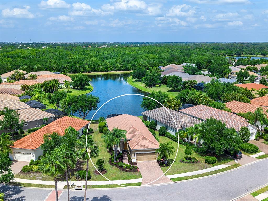 An aerial view shows a single-story house with a tiled roof and attached garage — 7263 BELLEISLE GLEN, LAKEWOOD RANCH, FL