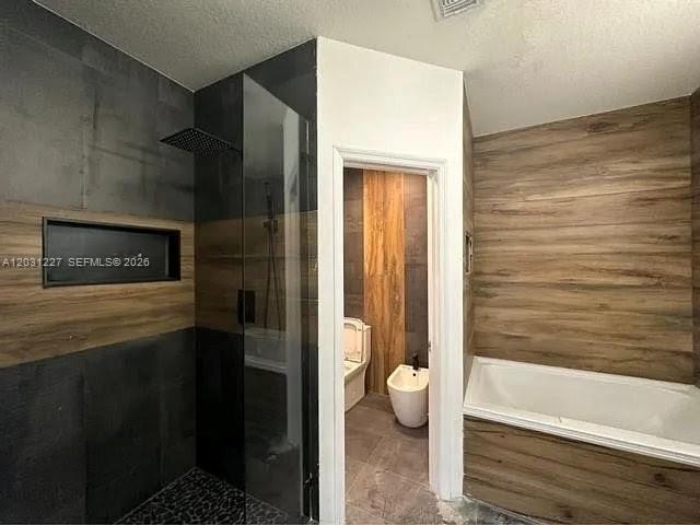 A bathroom features a glass-enclosed shower, a soaking tub, and a separate water closet area — 8042 NW 114th Pl, Doral FL 33178, DORAL, FL