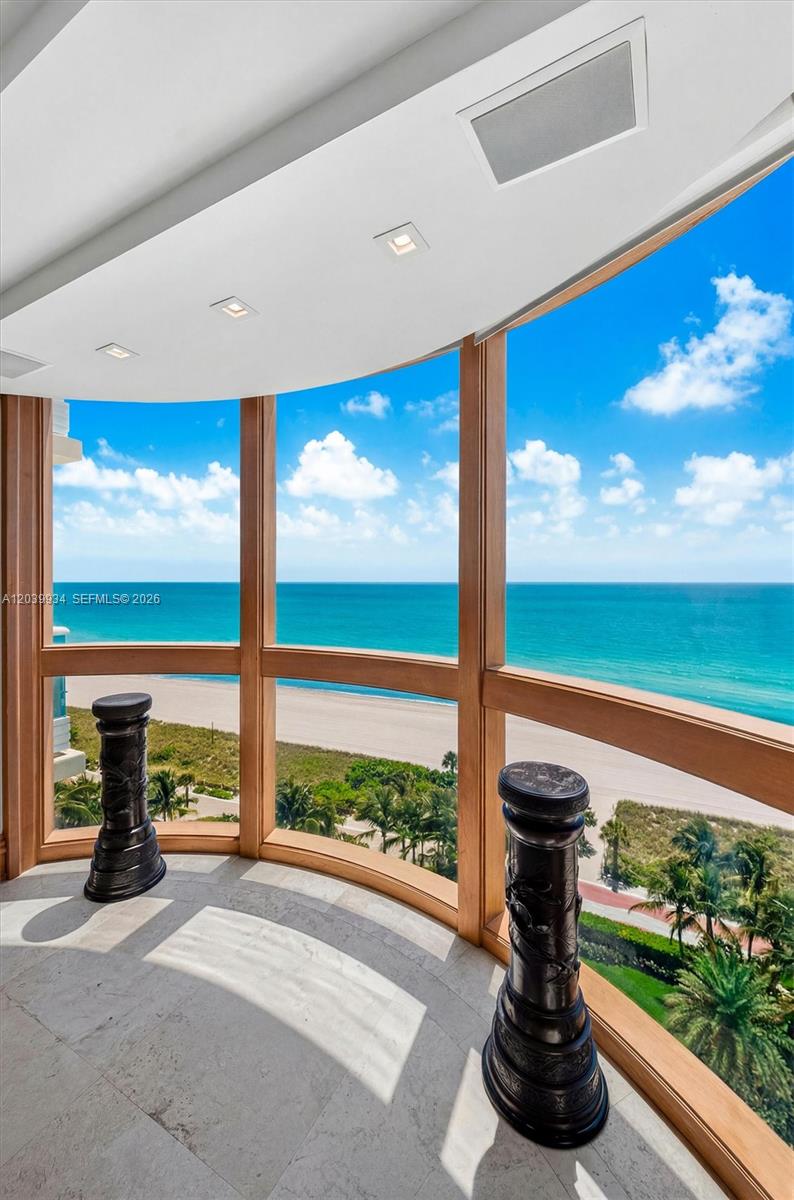 A curved window wall overlooks the ocean from a room with stone flooring — 5025 Collins Ave # 1105, Miami Beach FL 33140, MIAMI BEACH, FL