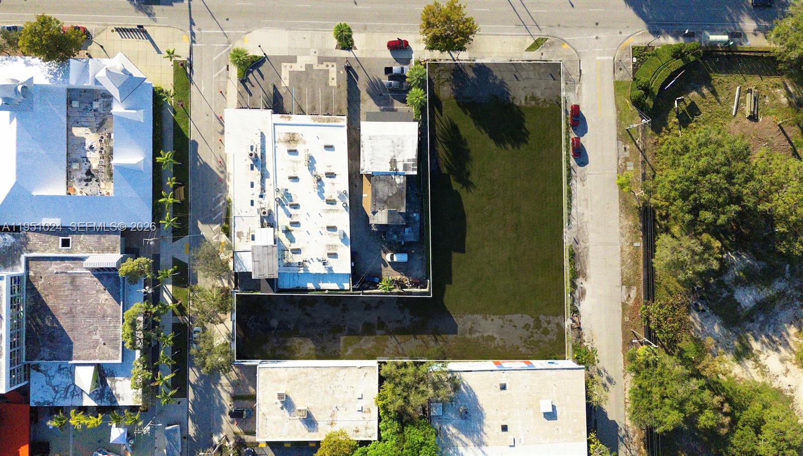 An aerial view shows a vacant rectangular lot adjacent to commercial buildings and paved streets — 5969 NE 2nd Ave, Miami FL 33137, MIAMI, FL