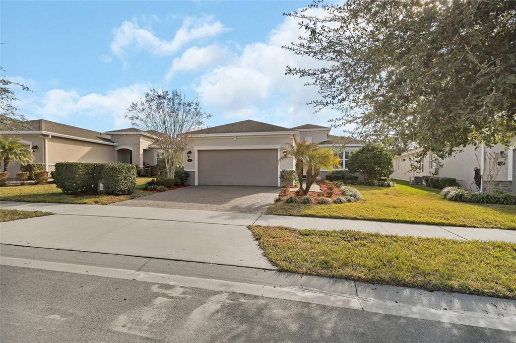 A single-story suburban house with a paved driveway, two-car garage, and landscaped front yard — 509 ADENMORE TERRACE, DELAND, FL