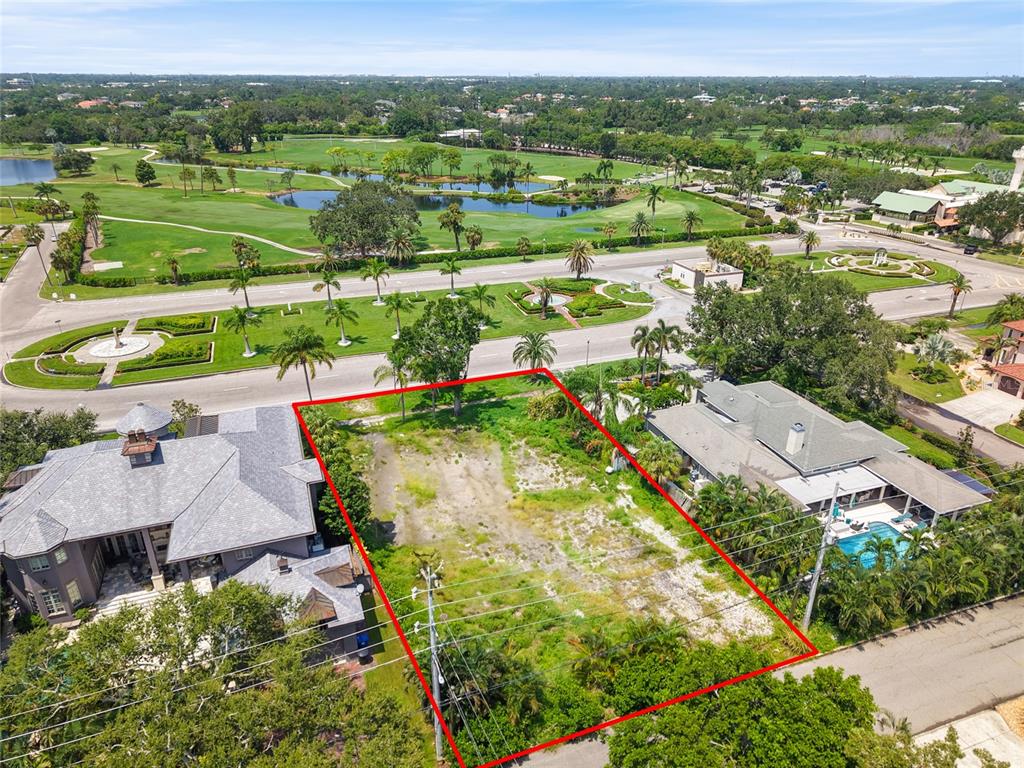 An aerial view shows a vacant, rectangular lot bordered by two houses and a road — 409 SNELL ISLE BOULEVARD NE, ST PETERSBURG, FL