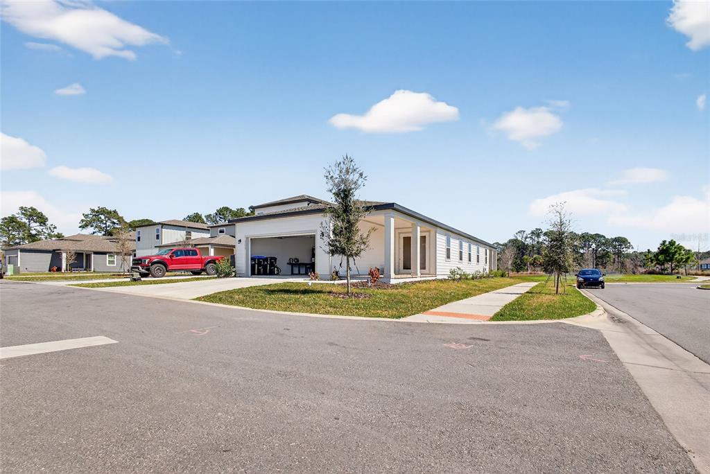 A white single-story house with a two-car garage and a red pickup truck parked outside — 17739 SHARP PUMMELO ALLEY, WINTER GARDEN, FL