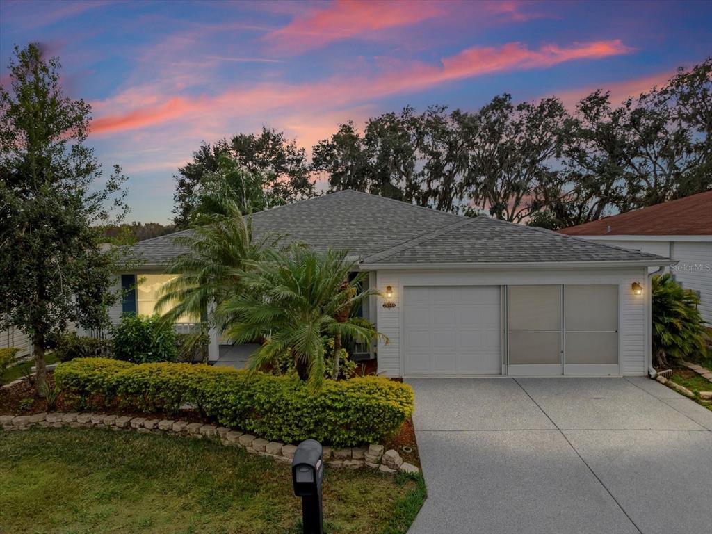 A single-story house with a white garage, a palm tree, and a manicured hedge — 29146 PRINCEVILLE DRIVE, SAN ANTONIO, FL