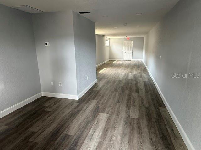 An empty room features light gray walls, recessed lighting, and wood-look vinyl plank flooring — 15 UTILITY DRIVE UNIT A, PALM COAST, FL