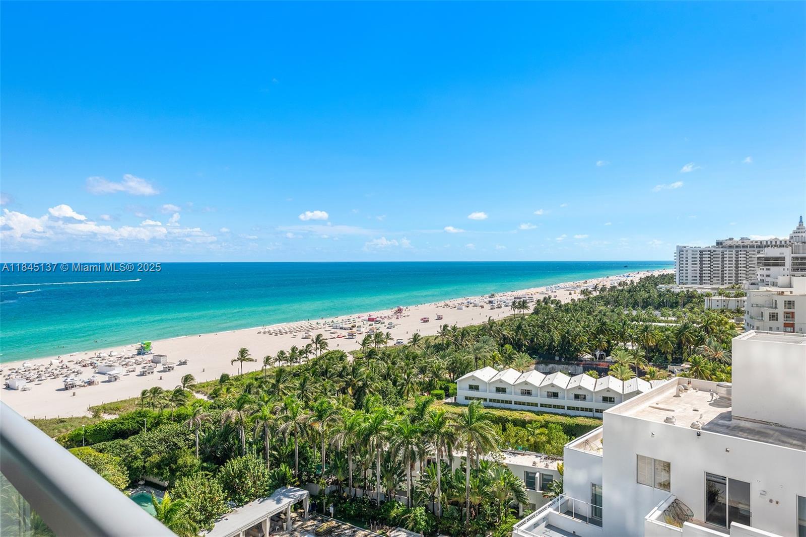 An elevated view shows a sandy beach, turquoise ocean, and surrounding palm trees and buildings — 101 20th St # 1706, Miami Beach FL 33139, MIAMI BEACH, FL
