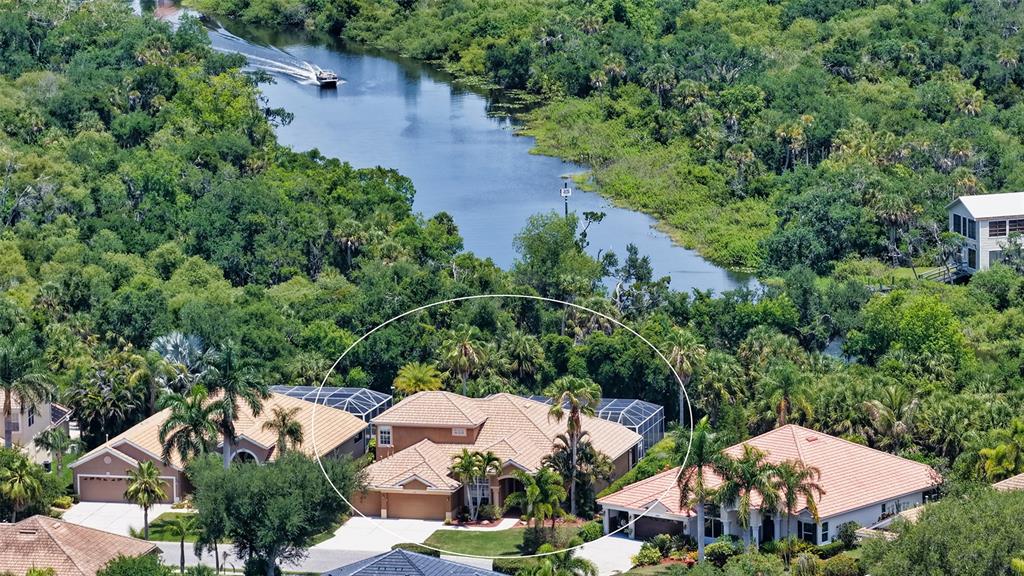 An aerial view of a suburban house with a tile roof and screened-in pool area — 6148 PALOMINO CIRCLE, BRADENTON, FL