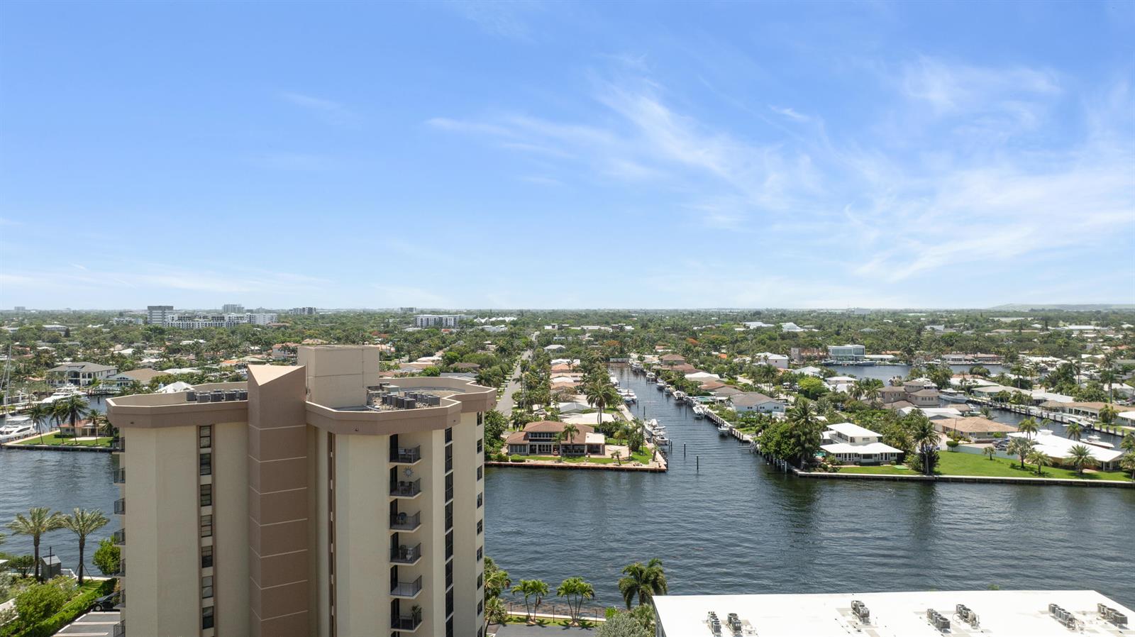 An elevated view shows a high-rise building overlooking a canal and residential neighborhood — 405 N Ocean Boulevard # 815, Pompano Beach FL 33062, POMPANO BEACH, FL