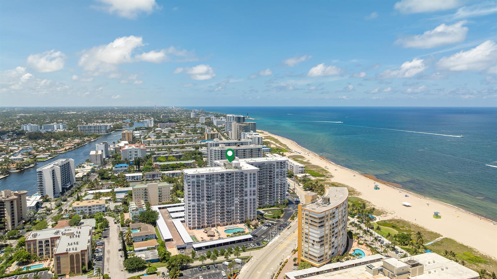 An aerial view shows a coastal high-rise apartment building near a beach and ocean — 405 N Ocean Boulevard # 815, Pompano Beach FL 33062, POMPANO BEACH, FL