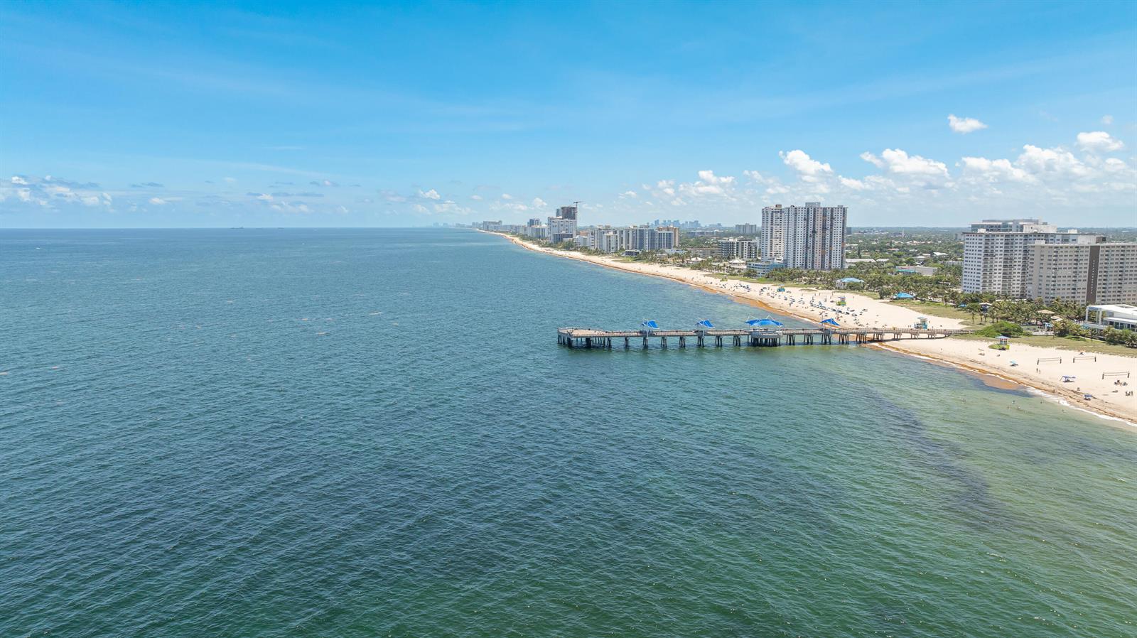 An aerial view of a long fishing pier extending into the ocean near a sandy beach — 405 N Ocean Boulevard # 815, Pompano Beach FL 33062, POMPANO BEACH, FL