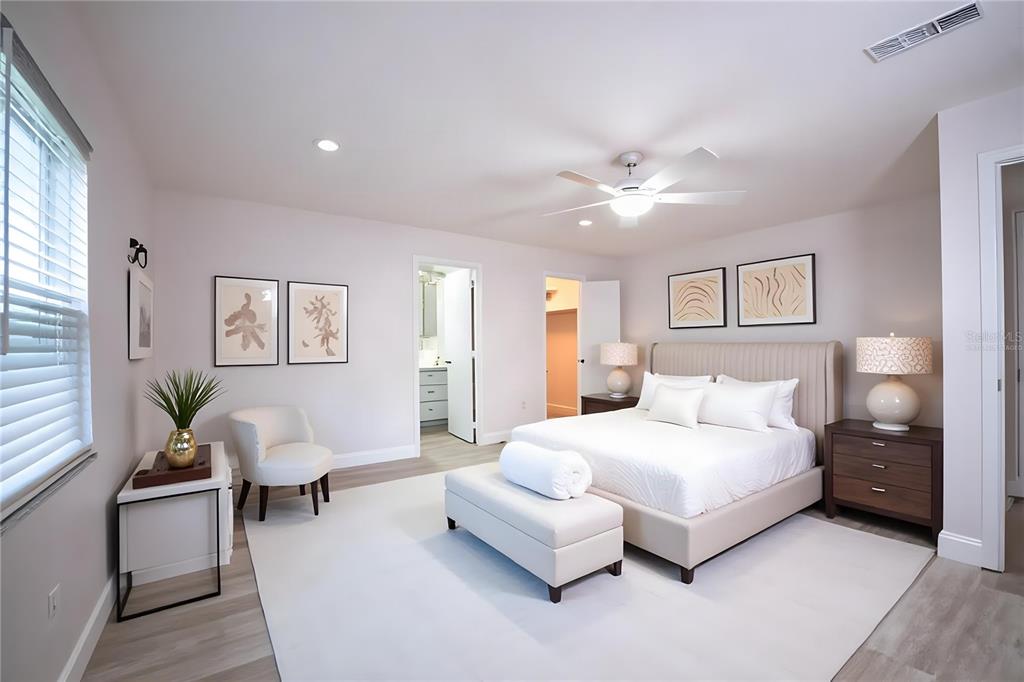 A bedroom features a bed with a beige headboard, a white bench, and two nightstands — 4090 OLD COLONY ROAD, MULBERRY, FL