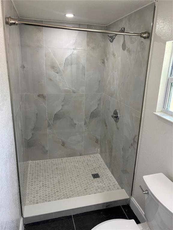 A kitchen with white cabinets, stainless steel appliances, and a central island on wood flooring — 4420 6TH AVENUE S, ST PETERSBURG, FL