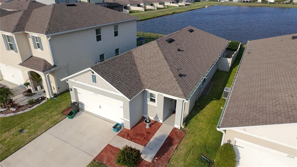 An aerial view shows a single-story suburban house with a gray roof and driveway — 3925 ANGOLA LANE, SANFORD, FL