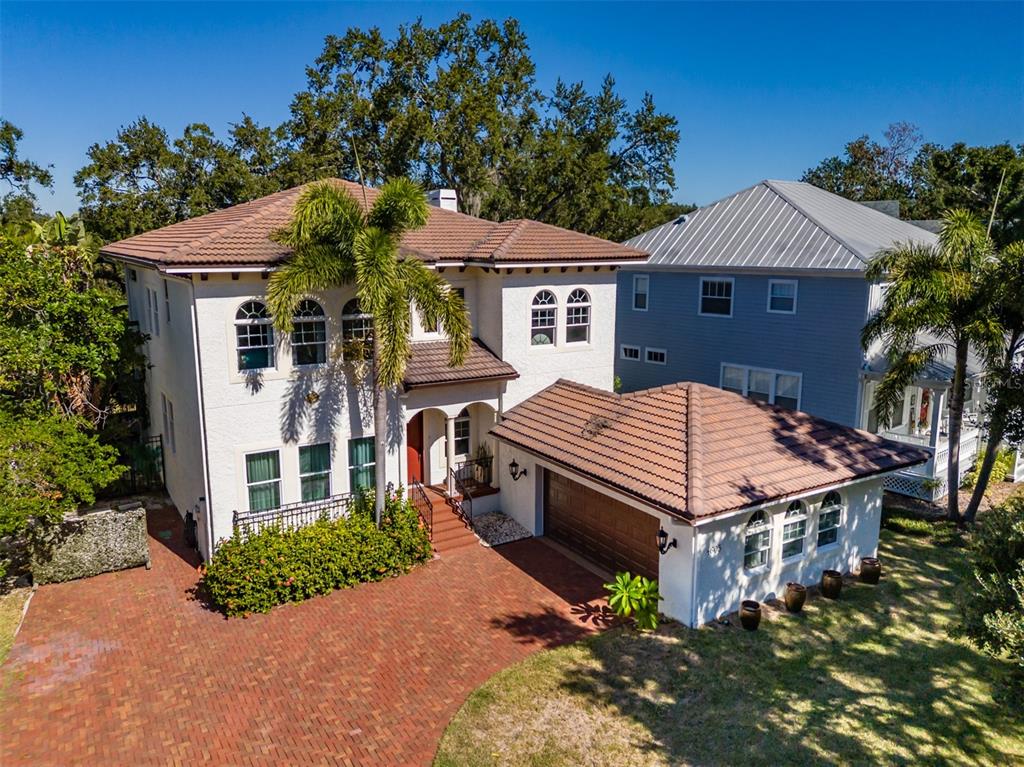 An aerial view of a two-story stucco house with a brick driveway and attached garage — 4605 W VASCONIA STREET, TAMPA, FL