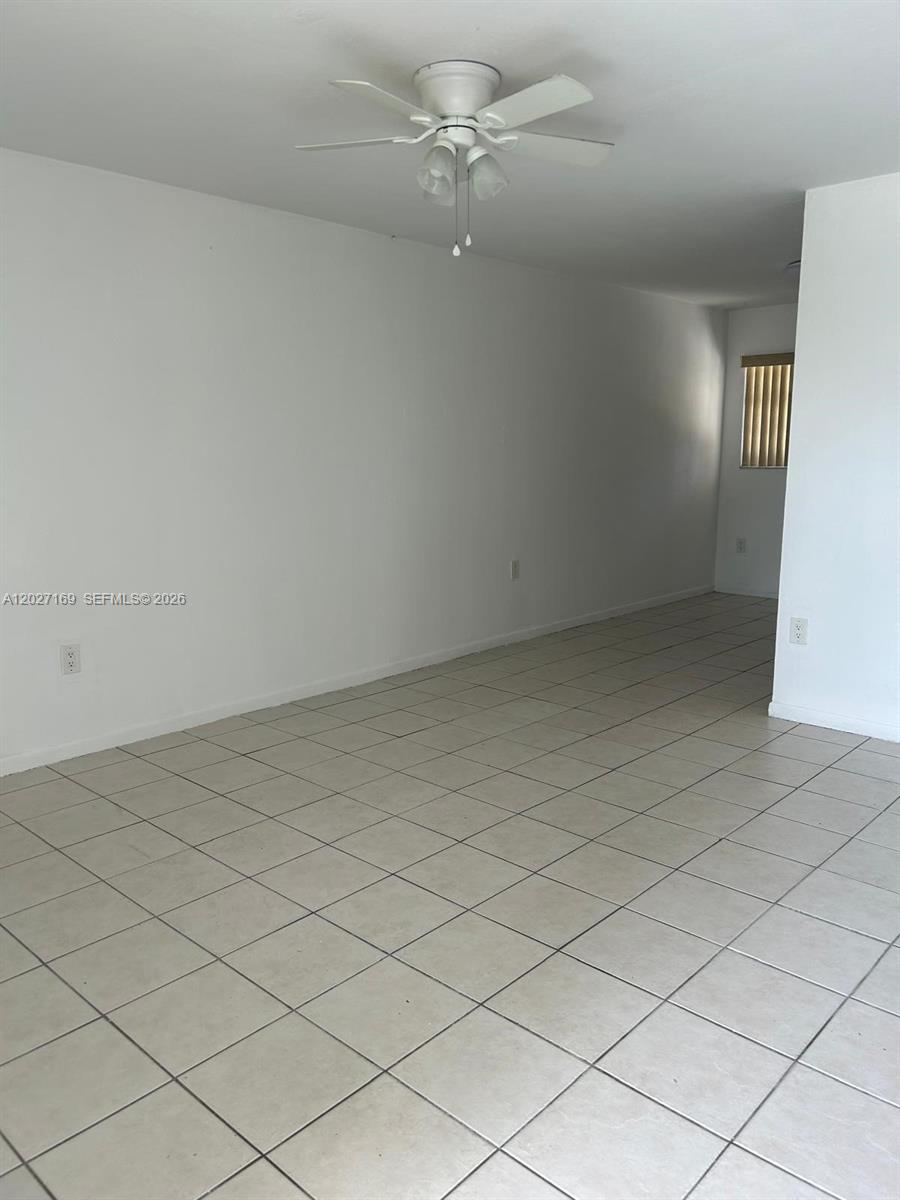 A bathroom features a white vanity, a glass-enclosed shower, and a toilet on tiled flooring — 1923 SW 99th Ter, Miramar FL 33025, MIRAMAR, FL