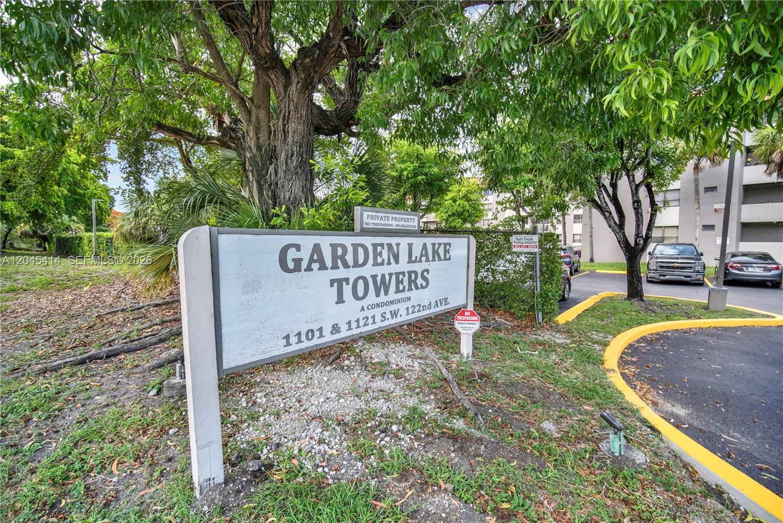 A sign for Garden Lake Towers stands in front of a building and parking lot — 1101 SW 122nd Ave # 205, Miami FL 33184, MIAMI, FL