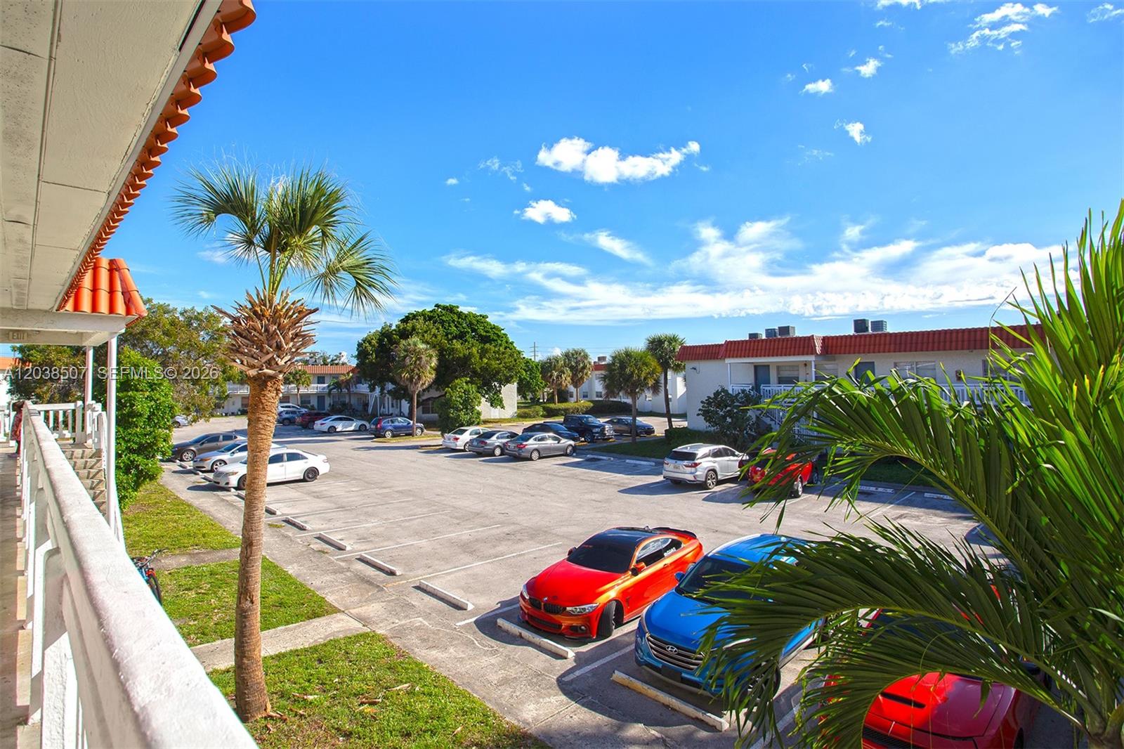 An elevated view of a parking lot surrounded by apartment buildings and palm trees — 1333 S Dixie Hwy # 222, Deerfield Beach FL 33441, DEERFIELD BEACH, FL