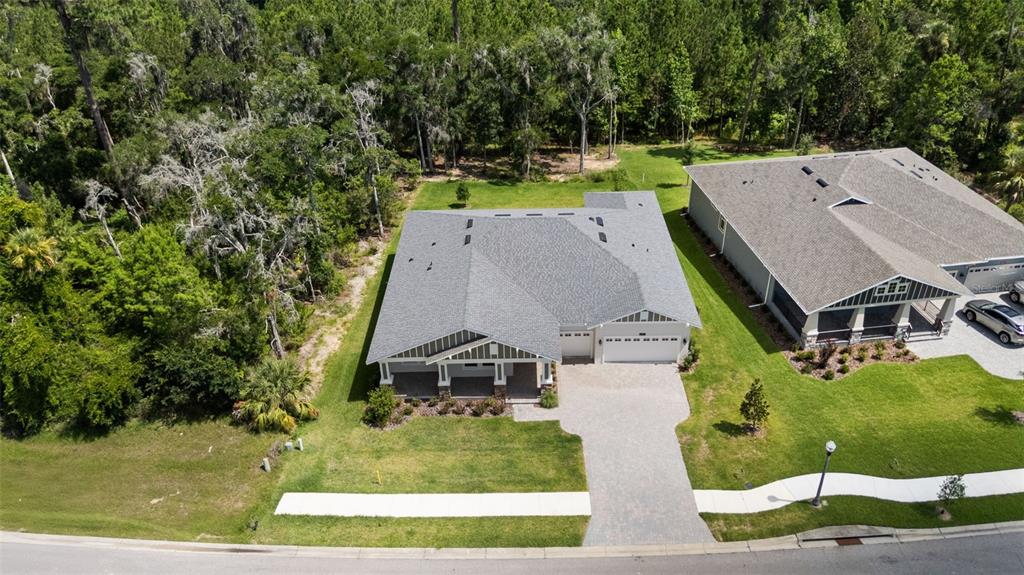 An aerial view shows a single-story house with a gray roof and paved driveway — 6671 SUMMIT VIEW DRIVE, BROOKSVILLE, FL