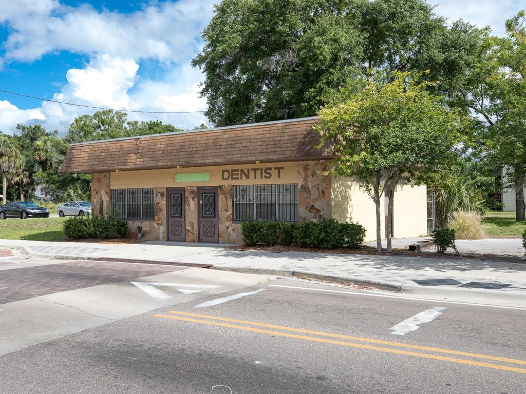 A single-story commercial building with a stone facade and a brown shingled roof — 1204 HISTORIC GOLDSBORO BOULEVARD, SANFORD, FL