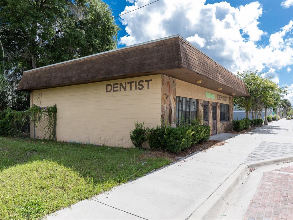 A single-story commercial building with tan block walls and a brown mansard roof — 1204 HISTORIC GOLDSBORO BOULEVARD, SANFORD, FL