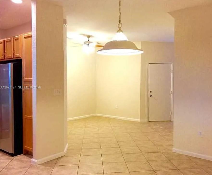 A dining area with tile floors, a pendant light, and a ceiling fan — 21115 NW 14th Pl # 2, Miami Gardens FL 33169, MIAMI GARDENS, FL