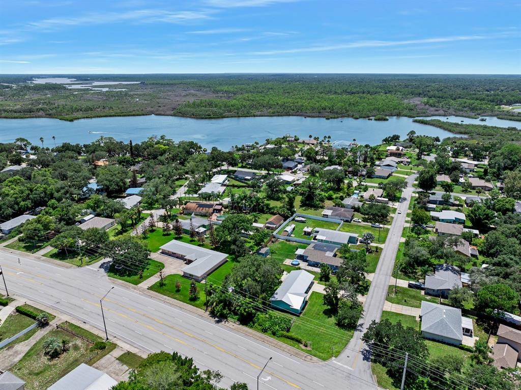 An aerial view shows a residential neighborhood situated along a large body of water — 311 ACACIA DRIVE, PORT ORANGE, FL