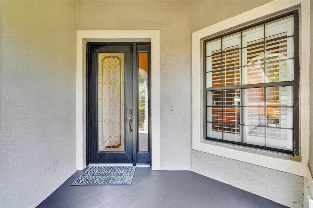 A front entryway features a dark door with a glass insert and a large window — 21 RIVER LANDING DRIVE, PALM COAST, FL