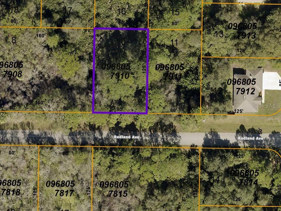 This is an aerial map showing a highlighted rectangular plot of land along a road — LOT 10 REDLAND AVENUE, NORTH PORT, FL